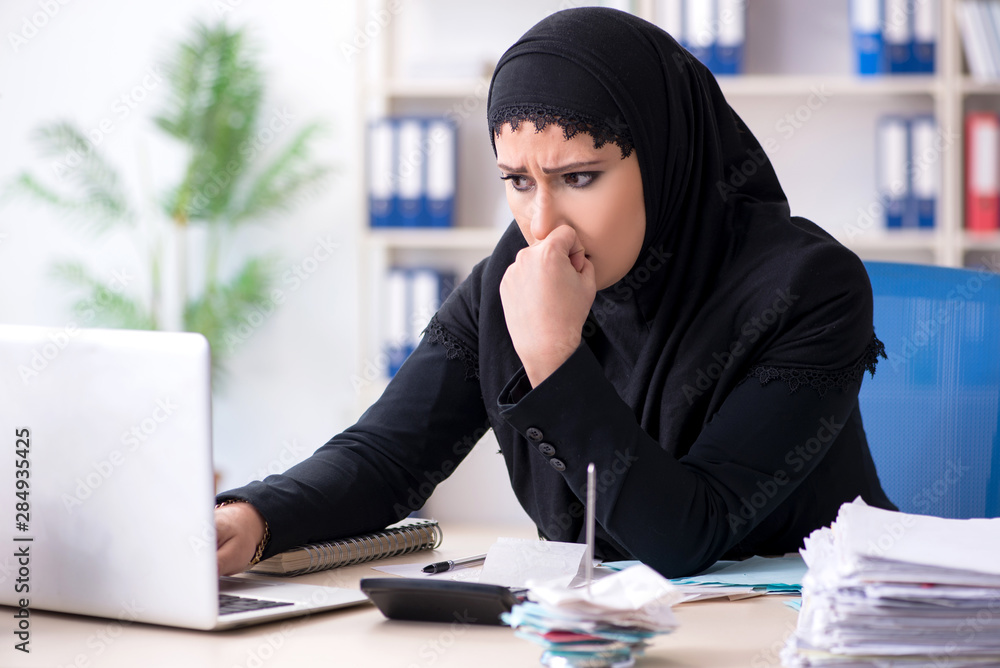 Female employee bookkeeper in hijab working in the office Female employee bookkeeper in hijab working in the office