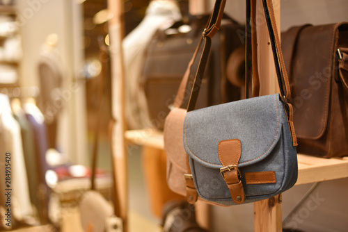 Blue shoulder bag canvas from the display or showcase in shopping mall, concept of fashion and lifestyle