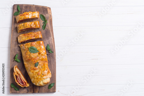 Konstfotografi Pizza roll stromboli with cheese salami olives and tomatoes