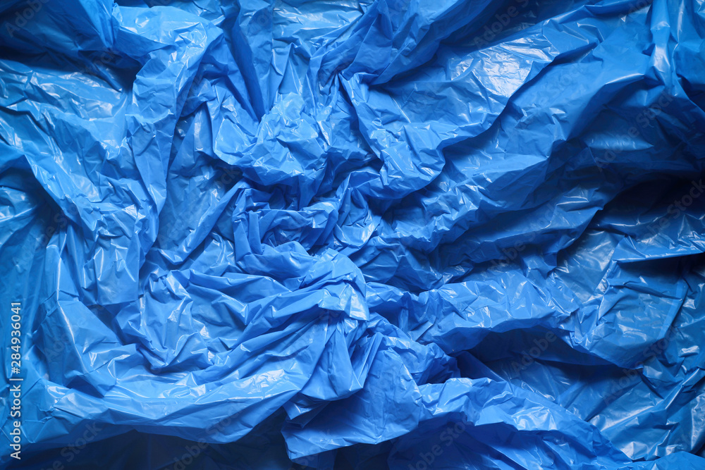 Fototapeta premium Blue crumpled plastic garbage bag texture background. Waste recycle concept. Pattern of materials.