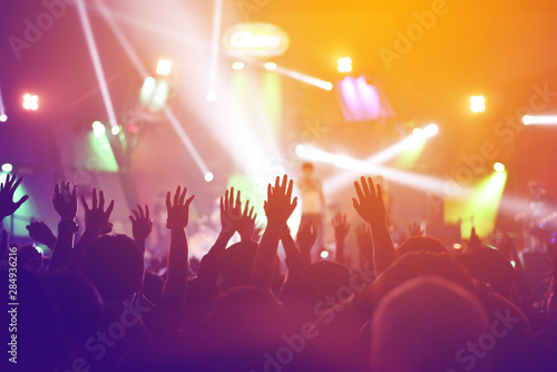 silhouettes of    Fun concert party rock disco light background.