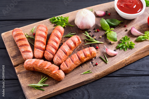 Fried sausages with herbs , spices and ketchup