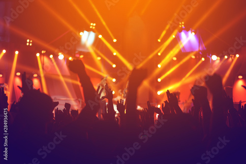 silhouettes of , Fun concert party rock disco light background.