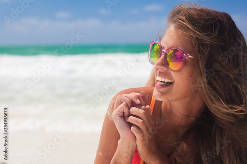 Portrait of happy young woman smiling at sea. Cuba, Cayo Largo