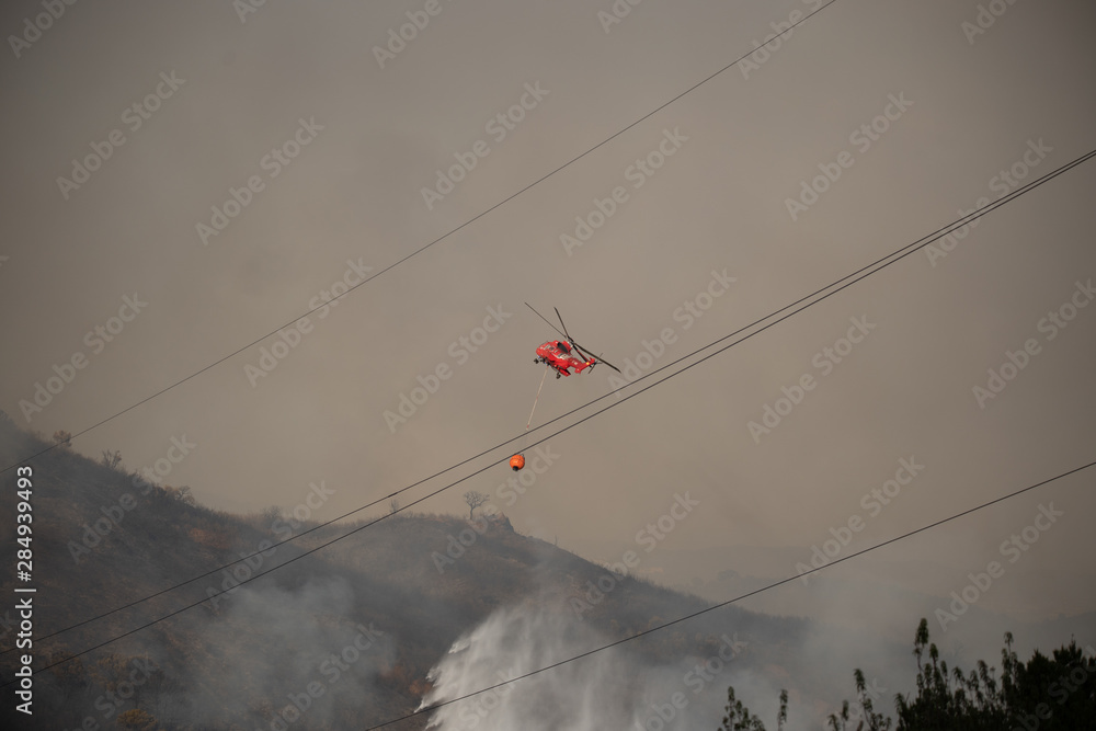 Helicopters putting out a forest fire in the Sierra Bermeja mountains in Estepona, Spain Helicopters putting out a forest fire in the Sierra Bermeja mountains in Estepona, Spain