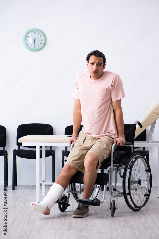 Young injured man waiting for his turn in hospital hall Young injured man waiting for his turn in hospital hall