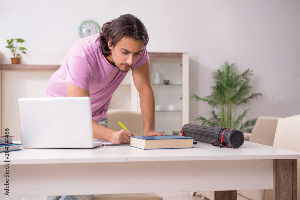 Young male student preparing for exams at home Young male student preparing for exams at home