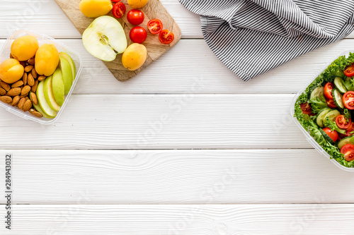 salad to go in lunch box on white wooden background top view space for text