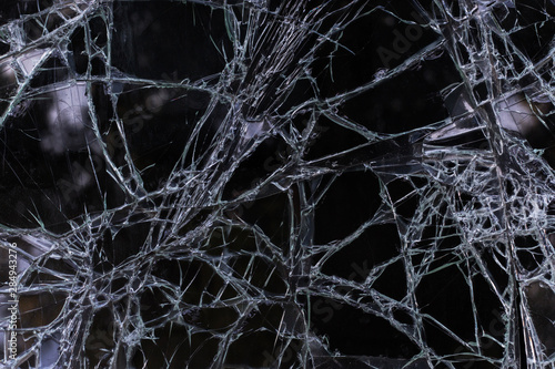 Broken glass texture with cracks closeup, macro