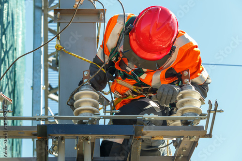 Working electrician works with electrical equipment