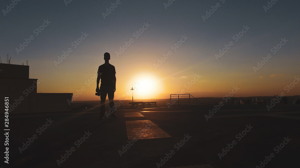Man photographer silhouette at sunset Man photographer silhouette at sunset