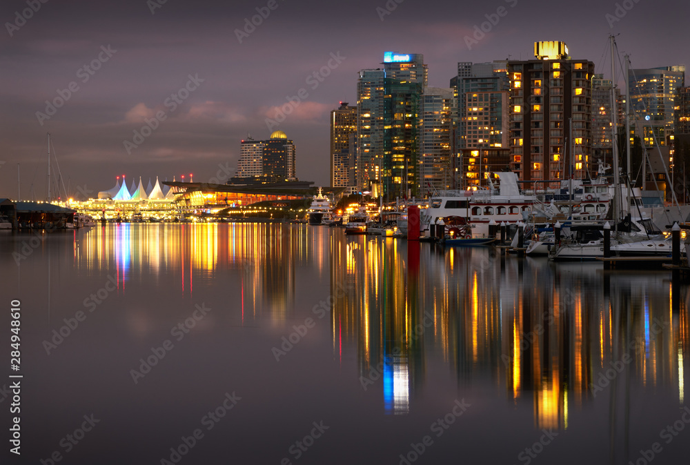 Fototapeta premium Coal Harbour Twilight Lights. The Vancouver skyline reflects in Coal Harbour at night. British Columbia, Canada.
