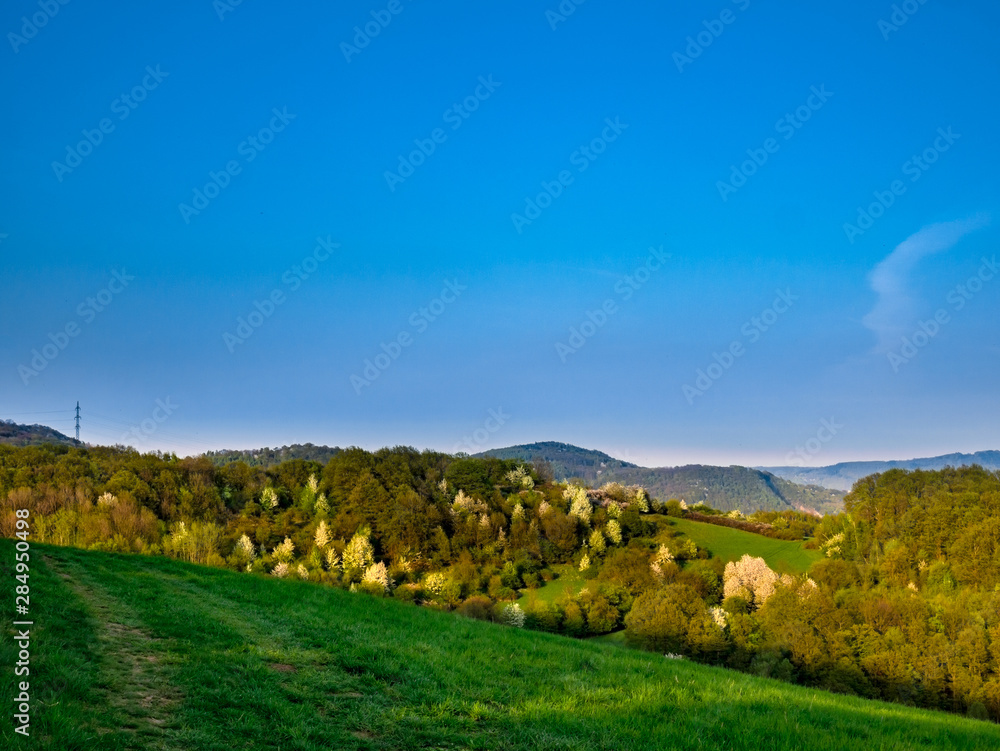 View of a mountainous landscape with an almost pure blue sky View of a mountainous landscape with an almost pure blue sky