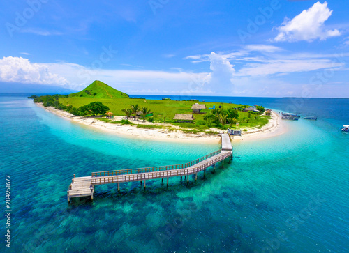 Top view of small isolated tropical island with white sandy beach and blue transparent water. Kenawa Island photo