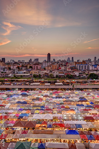 Market with colorful tents in sunset time. This is place in Thailand call Train Market