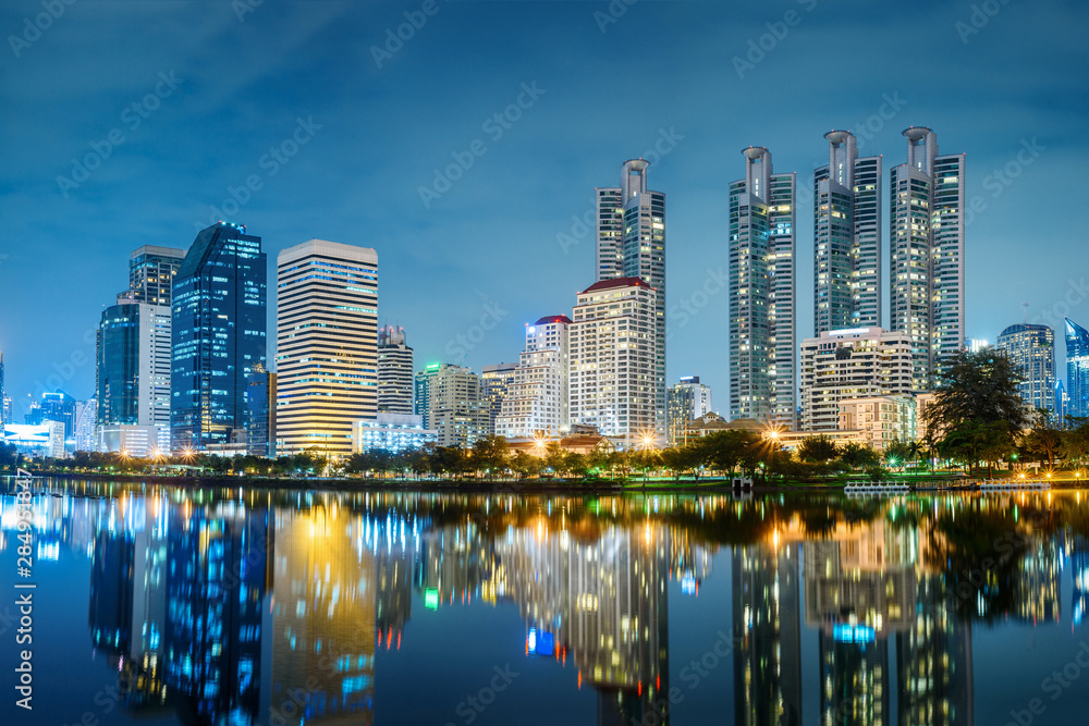 Fototapeta premium Bangkok city night skyline view in the business district with lake water reflection , Bangkok , Thailand