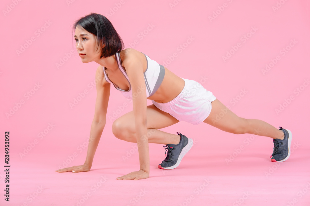 sport woman standing warm-up and stretch body before doing exercise on pink backgrounds, fitness concept, sport concept sport woman standing warm-up and stretch body before doing exercise on pink backgrounds, fitness concept, sport concept