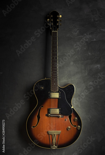 vintage guitar isolated on a black background © neosiam