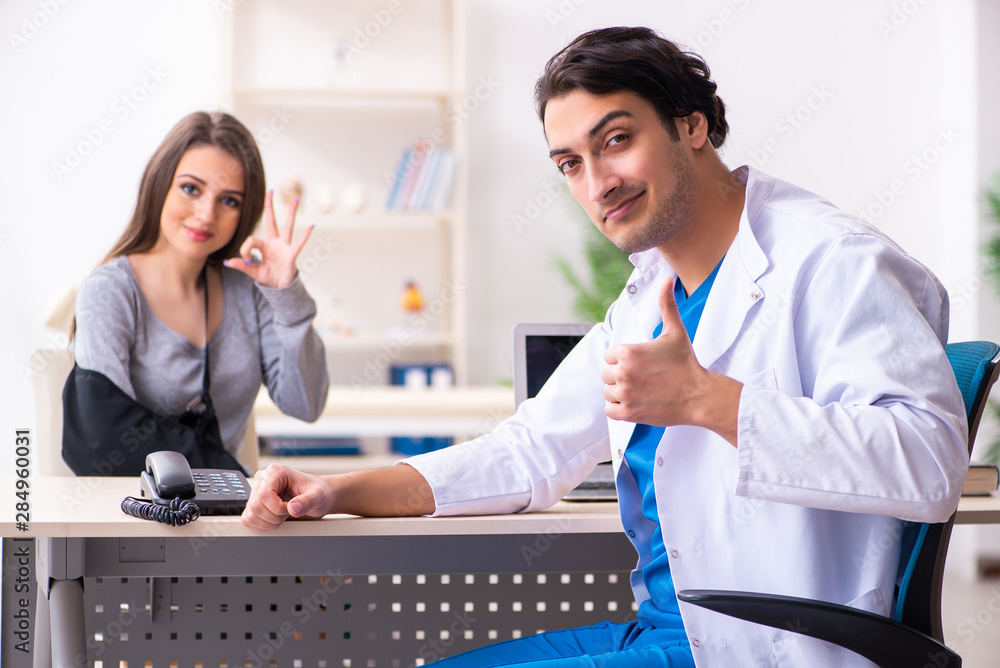 Fototapeta premium Young male doctor and female beautiful patient