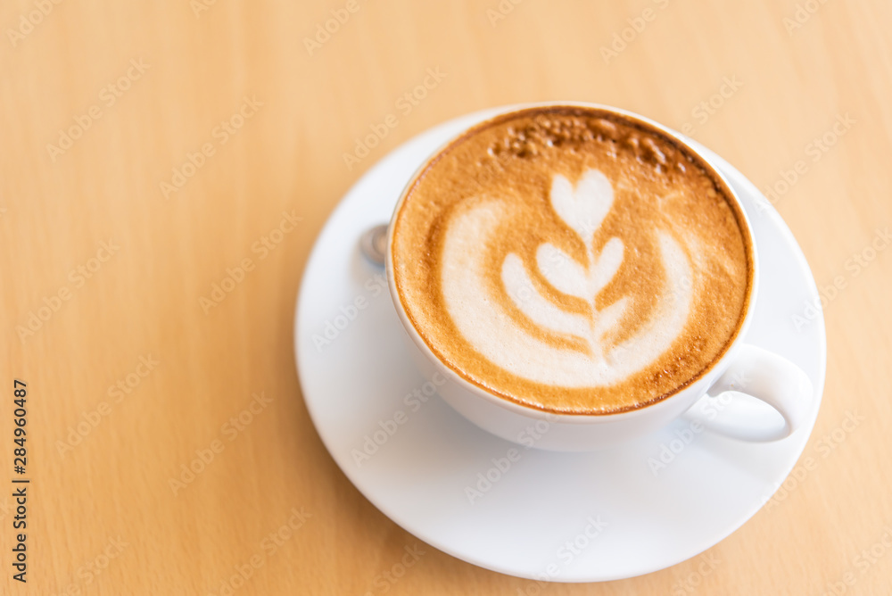Latte coffee in glass placed on wooden floor. Latte coffee in glass placed on wooden floor.