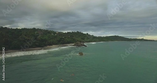 Manuel Antonio Beach Aerial Video in Costa Rica.  Beautiful ocean waves.  IN this serious you'll find all things thoughts about a tropical beach in paradise.  Surfers included photo