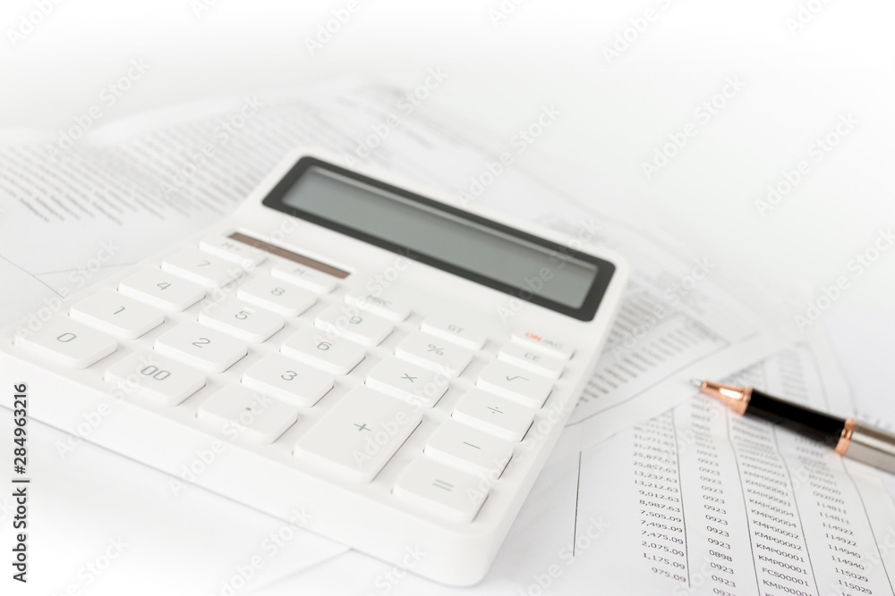 Business startup analysis summary report and using a calculator to calculate the numbers. Financial concept Business startup analysis summary report and using a calculator to calculate the numbers. Financial concept