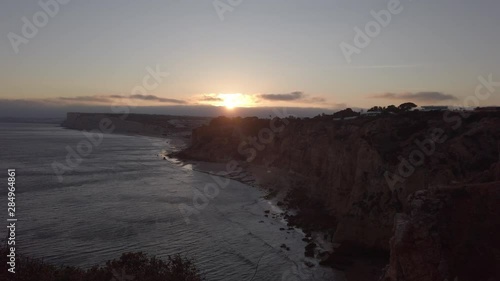 Wallpaper Mural The last rays of sunset silhouette Lagos coastal cliffs, Portugal, wide. Torontodigital.ca