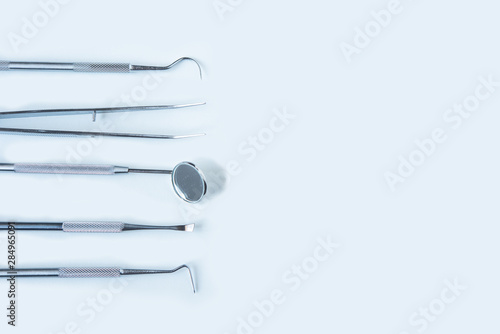  close up dentist tools for teeth care at white background top view