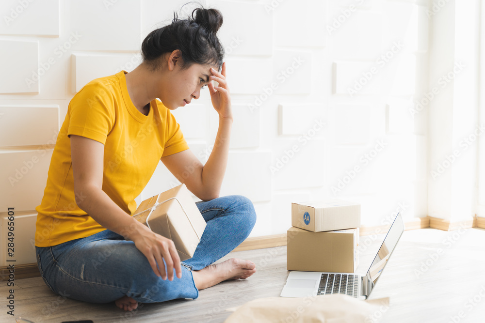 Asian freelance woman working at home and start up small business entrepreneur SME with internet online. Young women are worried about lower sales of online businesses. Asian freelance woman working at home and start up small business entrepreneur SME with internet online. Young women are worried about lower sales of online businesses.