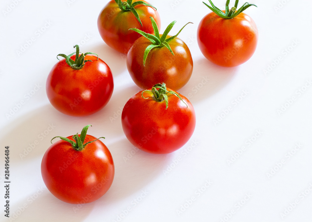 small red cherry tomatoes on white background small red cherry tomatoes on white background