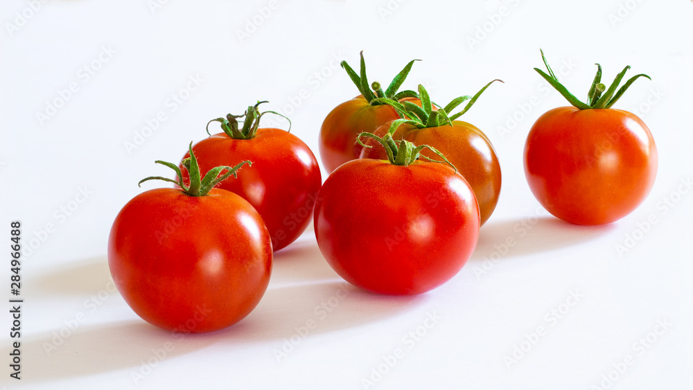 small red cherry tomatoes on white background small red cherry tomatoes on white background