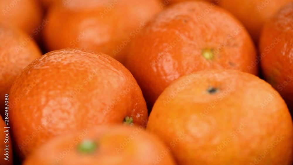 Portion of fresh tangerines (seamless loopable, 4K UHD)