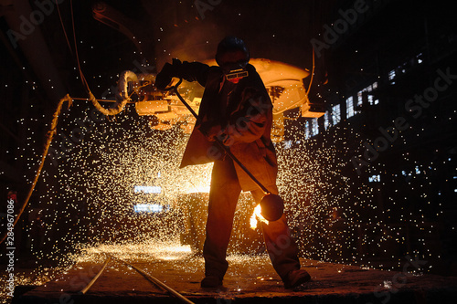 Steelmaker at ingot casting. Electric arc furnace shop EAF. Metallurgy.