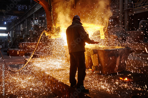 Steelmaker at ingot casting. Electric arc furnace shop EAF. Metallurgy. photo