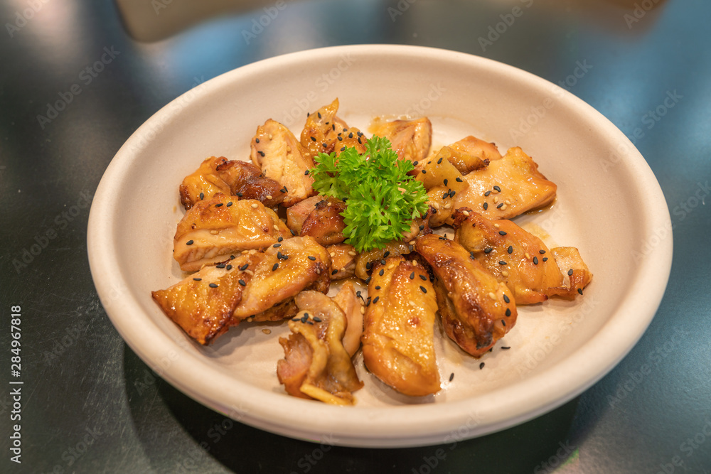Korean fried chicken with soy sauce decorated with parsley Korean fried chicken with soy sauce decorated with parsley