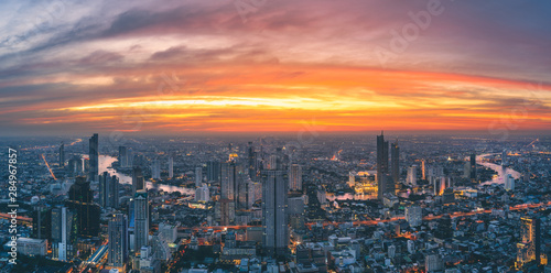 Panorama of Bangkok city river curved skyline with sunset light.