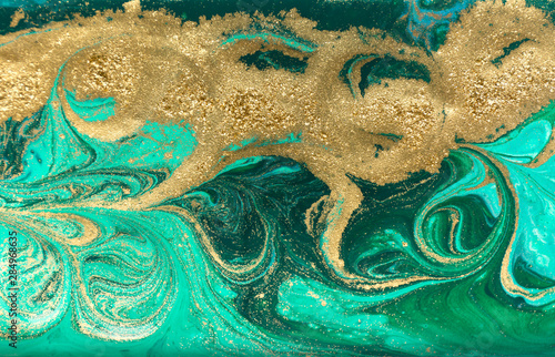 Green and gold marbling pattern. Golden powder marble liquid texture.