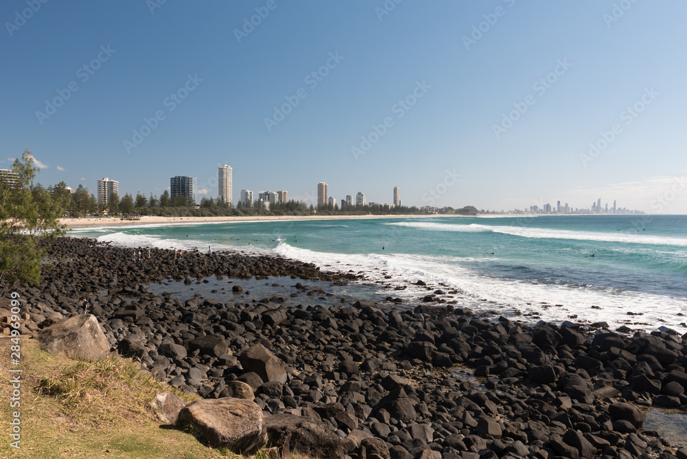 Burleigh Heads Beach with black, basalt rocks on the foreshore, Gold Coast, Queensland, Australia. Burleigh Heads Beach with black, basalt rocks on the foreshore, Gold Coast, Queensland, Australia.