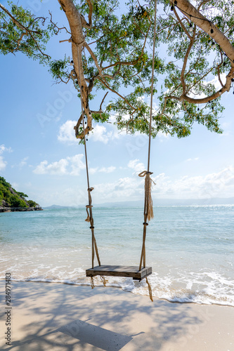 Swing hang from tropical tree over summer beach sea in Koh Phangan island , Thailand. Summer, travel, vacation and holiday concept