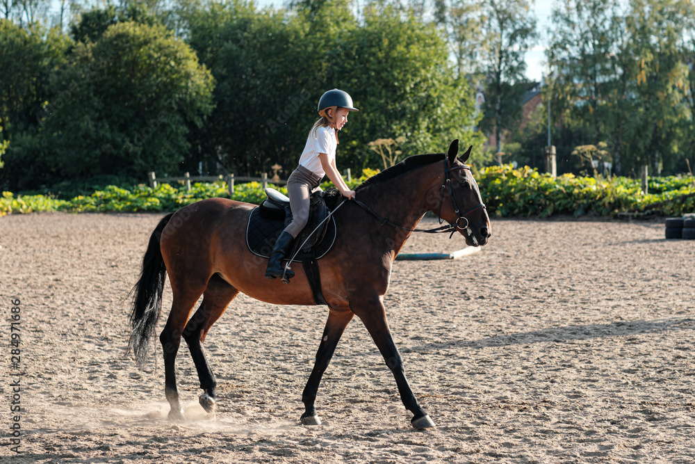 Girl teenager jockey trains on the field and at the hippodrome. Girl teenager jockey trains on the field and at the hippodrome.