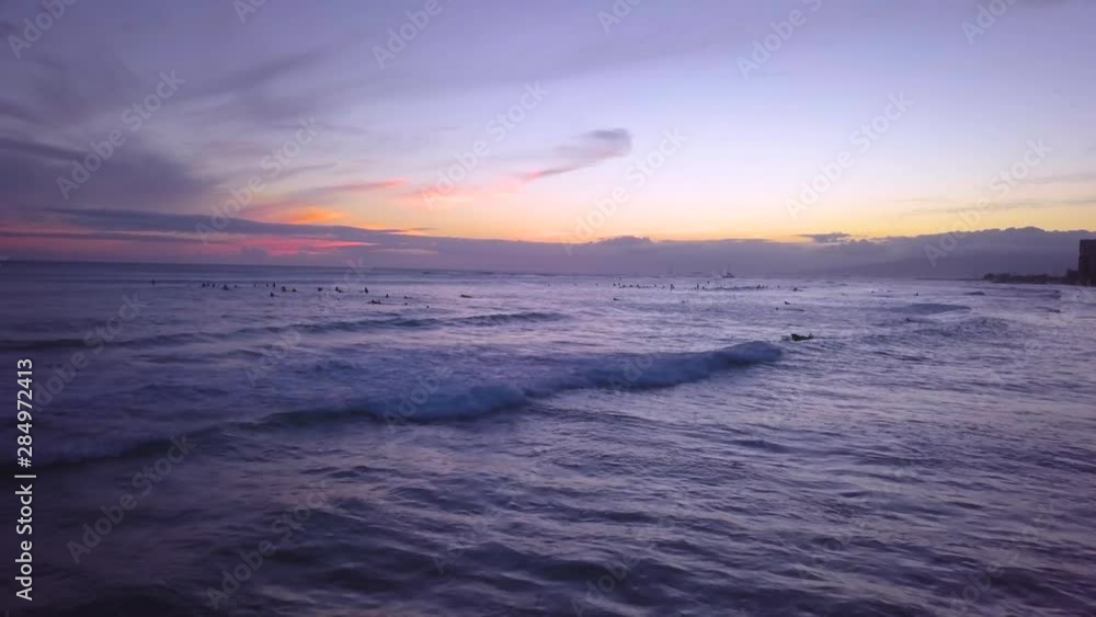 Surfers enjoy the sunset at Waikiki as they catch their final waves at dusk on the Hawaiian island of Oahu. Surfers enjoy the sunset at Waikiki as they catch their final waves at dusk on the Hawaiian island of Oahu.