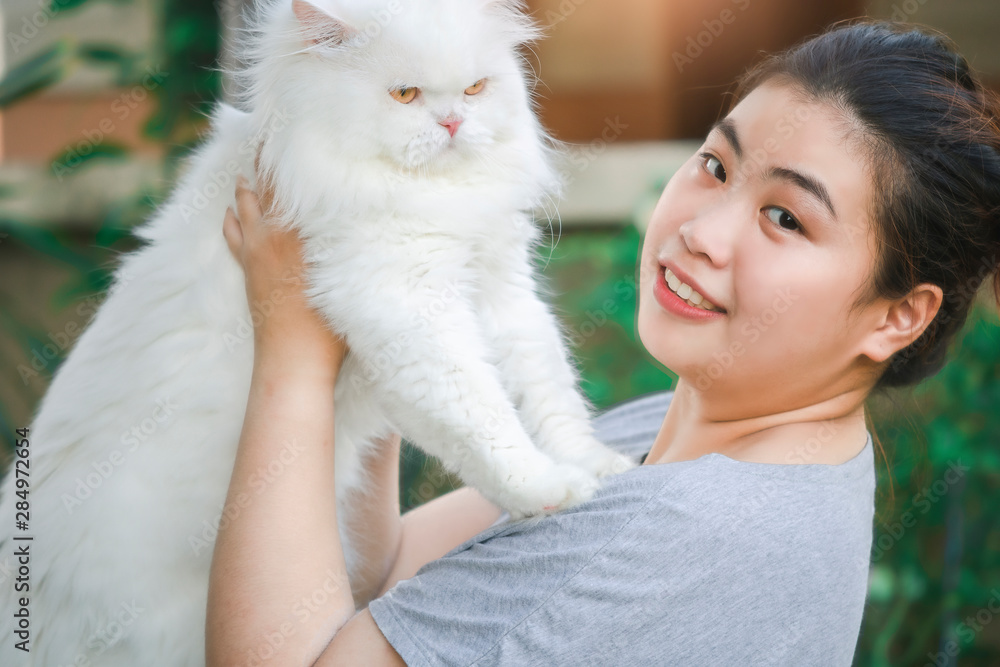 Asian beautiful woman cuddling carry white persian cat Long hair on nature blurred background for lifestyle in home with friendship cuddling image Asian beautiful woman cuddling carry white persian cat Long hair on nature blurred background for lifestyle in home with friendship cuddling image