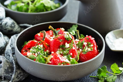 Baked bell peppers salad with herbs and garlic. Eastern dish.