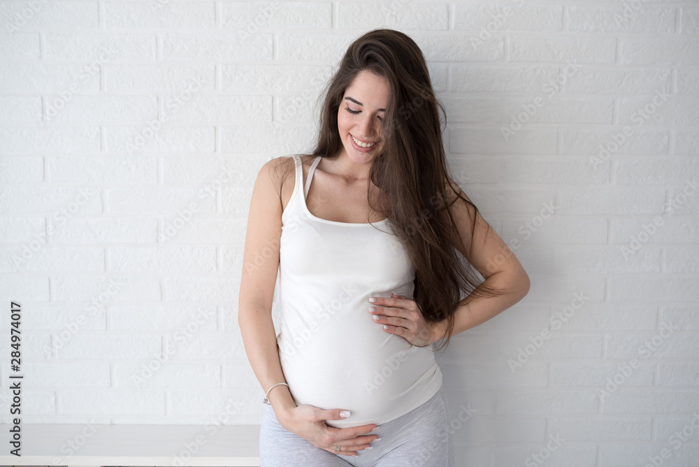 Beautiful young smiling pregnant woman. Happiness Beautiful young smiling pregnant woman. Happiness