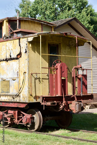 Close up view of an antique deteriorated wooden railway train caboose photo