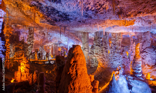 Colorful illuminated stalactites at Stalactites Cave also known as Soreq Cave and Avshalom Cave © vadiml