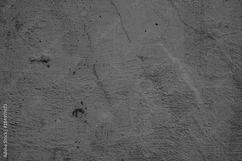 Texture of a concrete wall with cracks and scratches which can be used as a background Texture of a concrete wall with cracks and scratches which can be used as a background