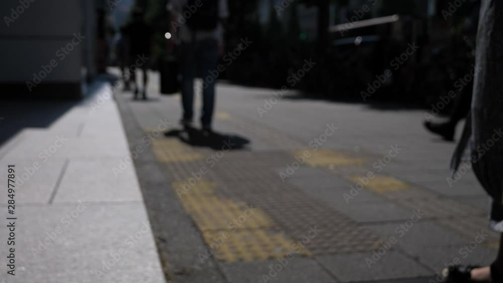 Blurred slow motion background of people walking down the road Blurred slow motion background of people walking down the road