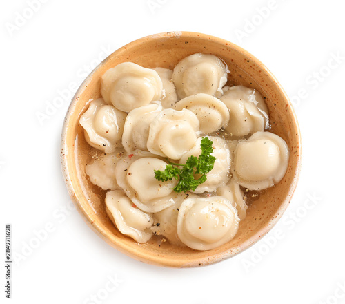 Bowl of tasty dumplings in broth isolated on white, top view
