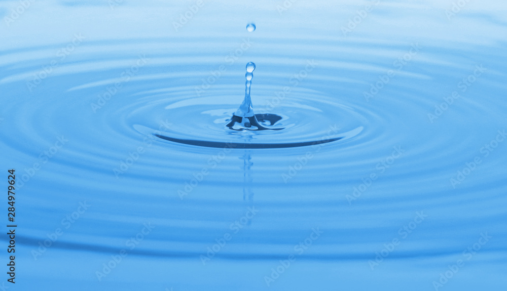 Splash of blue water with drop, closeup Splash of blue water with drop, closeup
